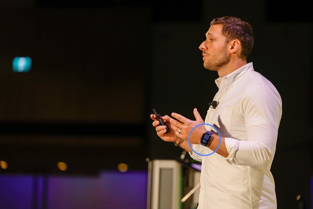 David Zagury speaking on stage at SocialWest Calgary, wearing the QR code Apple Watch face (circled)